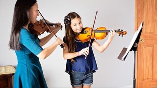 Julienne Ikegami playing a duet with a violin student